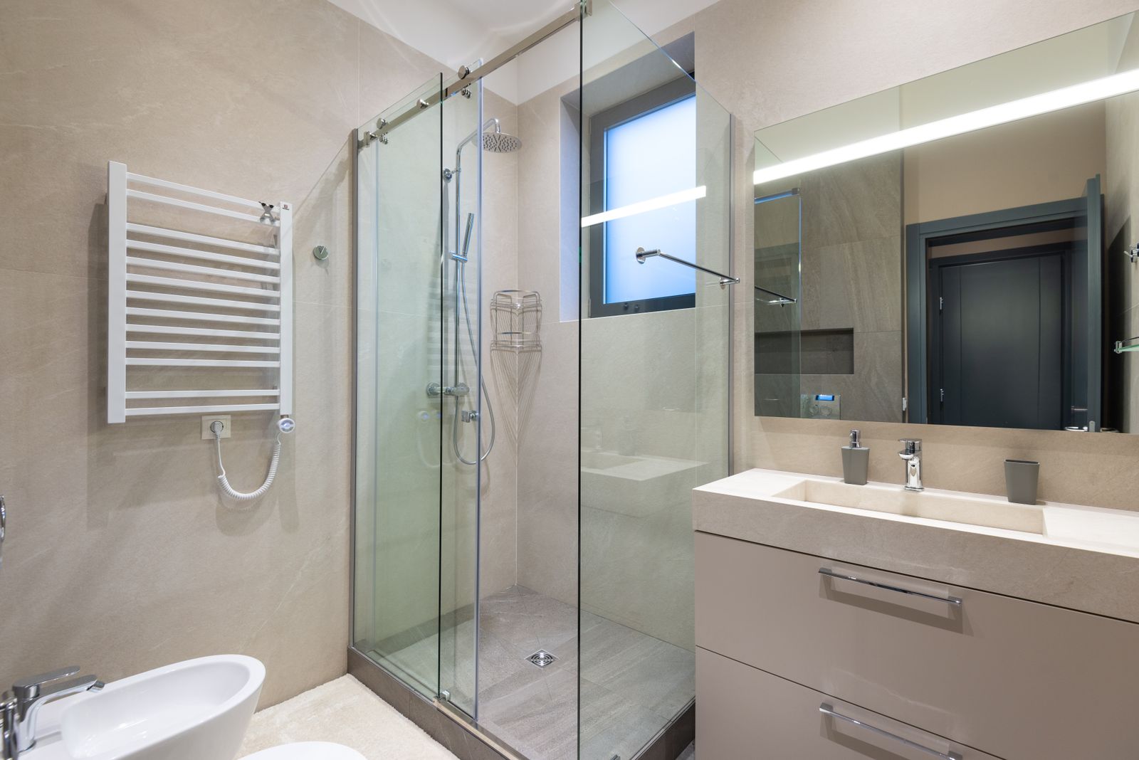 Bright accessible bathroom with a low-threshold walk-in shower and grab bars