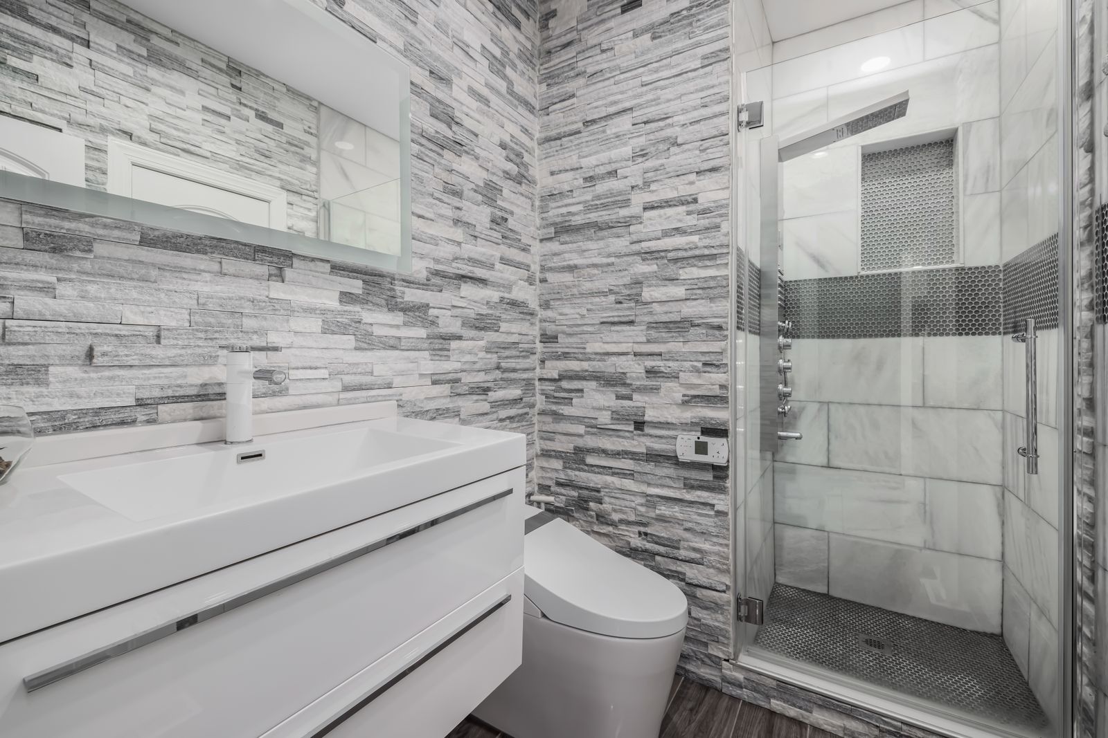 Low-threshold walk-in shower with a fold-down seat and grab bars