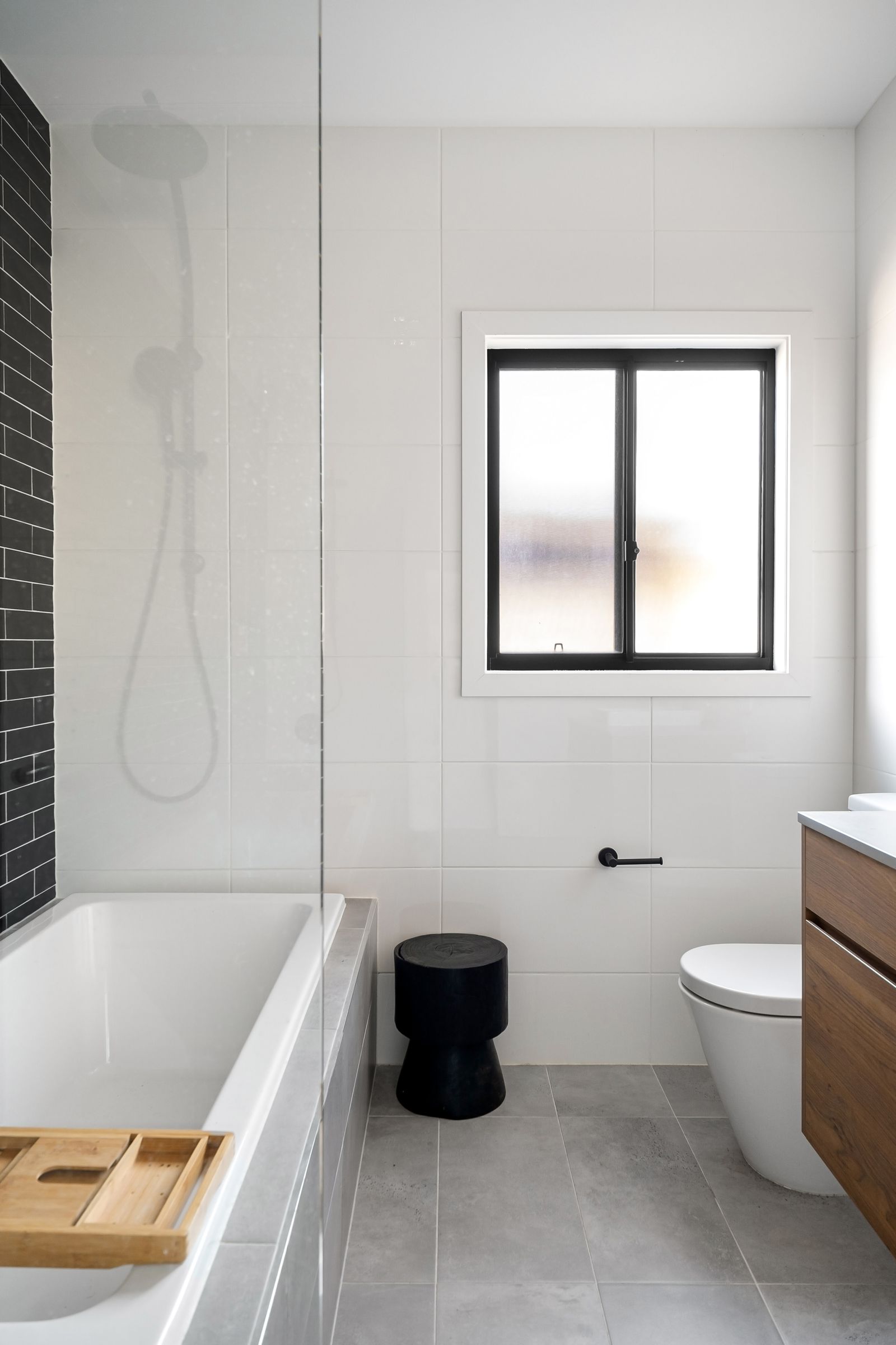Walk-in bathtub with a sealed door, built-in seat and handheld shower